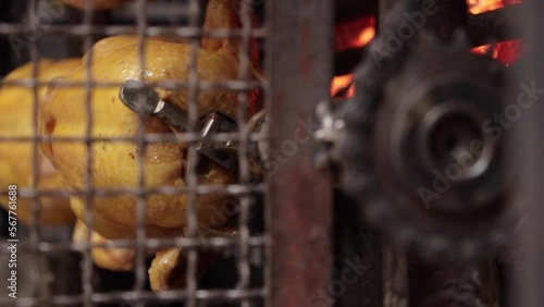 Whole roast chicken turning on spit. Street food barbecue. Cooking chicken barbecue.