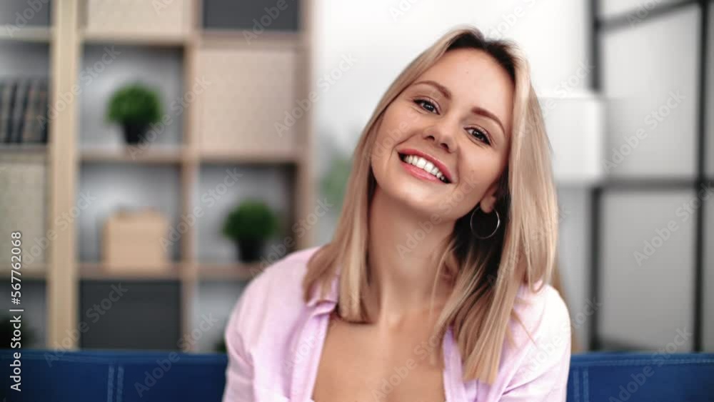 Portrait cute young blonde woman with perfect skin and natural beauty smiling at cozy living room Portrait cute young blonde woman with perfect skin and natural beauty smiling at cozy living room