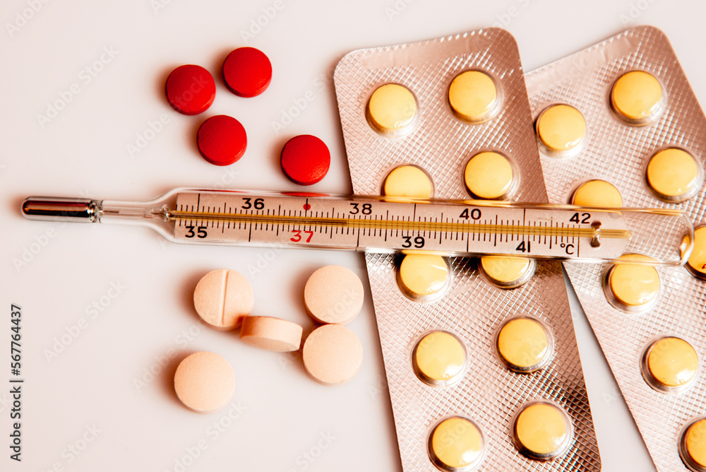 Abstract image of a thermometer with high temperature and medication (Сovid - concept).