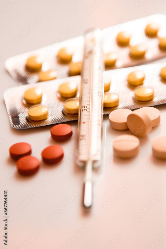 Abstract image of a thermometer with high temperature and medication (Сovid - concept).