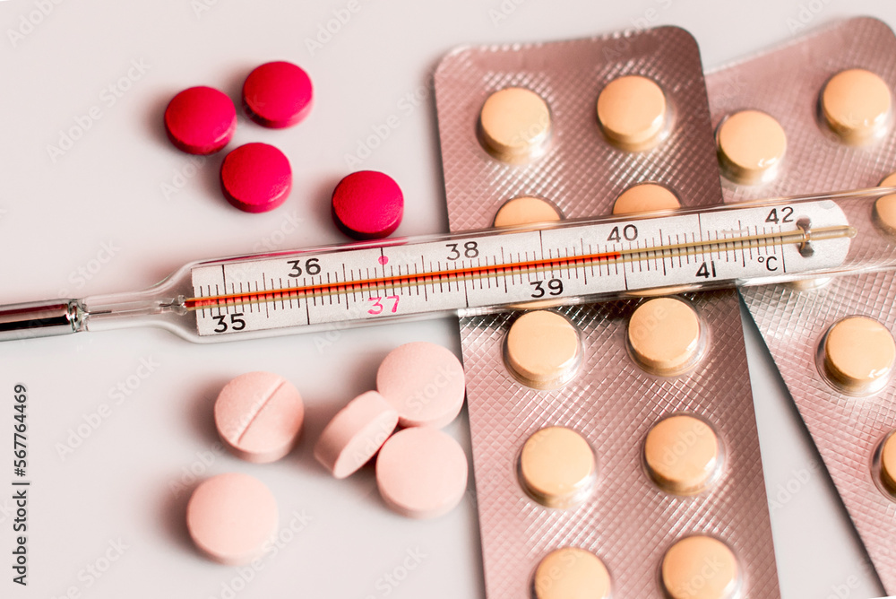 Abstract image of a thermometer with high temperature and medication (Сovid - concept).