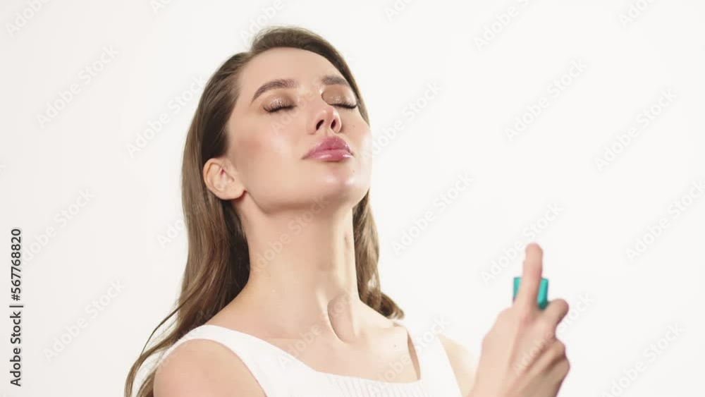 Young woman spraying micellar water on face. Beauty woman using moisturizer bottle for spraying face. Female skincare. Girl face skin cleaning procedure at morning Young woman spraying micellar water on face. Beauty woman using moisturizer bottle for spraying face. Female skincare. Girl face skin cleaning procedure at morning