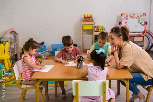 Obraz Children in the daycare are drawing on the table