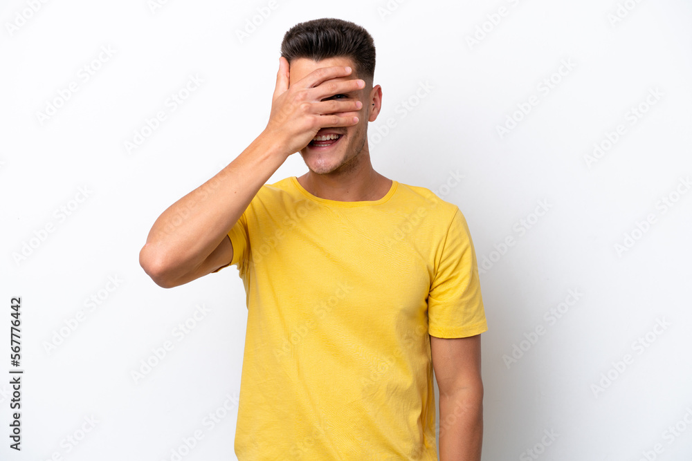 Young caucasian man isolated on white background covering eyes by hands and smiling Young caucasian man isolated on white background covering eyes by hands and smiling