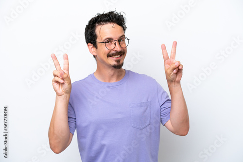 Young man with moustache isolated on white background showing victory sign with both hands