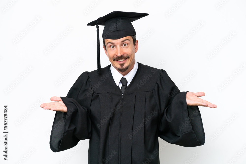 Young university graduate man isolated on white background having doubts while raising hands Young university graduate man isolated on white background having doubts while raising hands