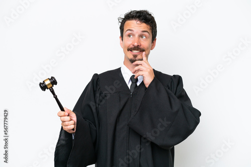 Young judge caucasian man isolated on white background thinking an idea while looking up