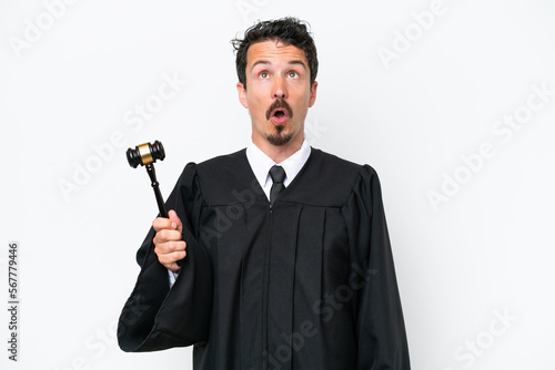 Young judge caucasian man isolated on white background looking up and with surprised expression