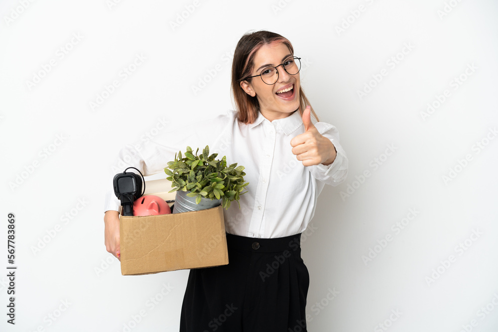 Young caucasian woman moving in new home among boxes isolated on white background with thumbs up because something good has happened Young caucasian woman moving in new home among boxes isolated on white background with thumbs up because something good has happened