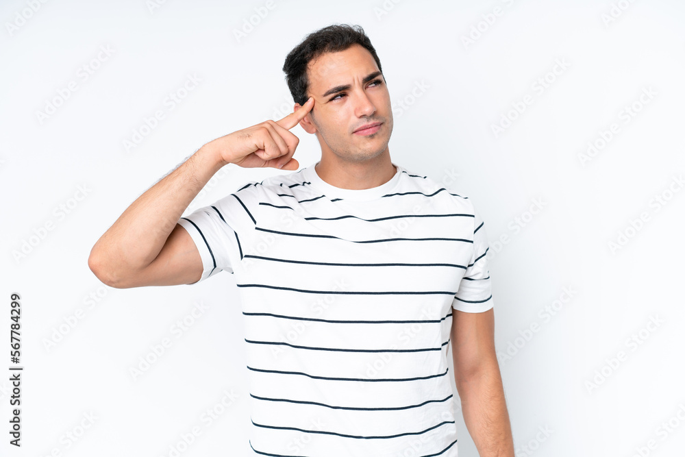 Young caucasian man isolated on white background making the gesture of madness putting finger on the head Young caucasian man isolated on white background making the gesture of madness putting finger on the head