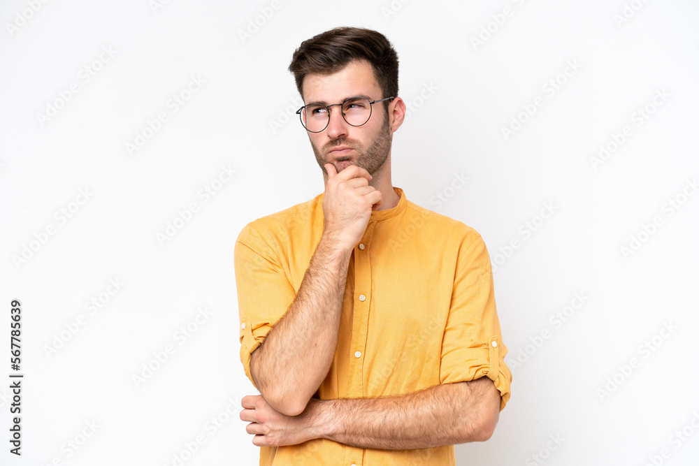 Young caucasian man isolated on white background having doubts and thinking Young caucasian man isolated on white background having doubts and thinking