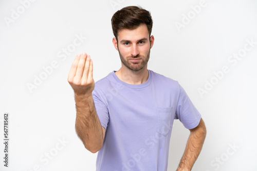 Young caucasian man isolated on white background making Italian gesture