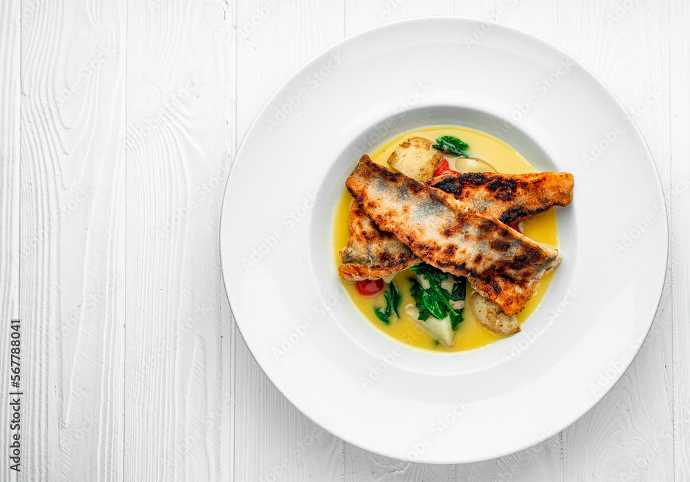 Fried perch fillet with boiled potatoes in a creamy sauce Fried perch fillet with boiled potatoes in a creamy sauce