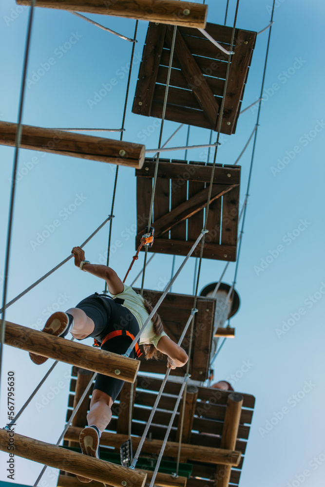 Girl walking on planks high up in the air Girl walking on planks high up in the air