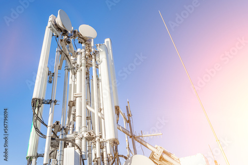 GSM antennas on a high tower against the blue sky, 5g, 4g antennas for cellular communication, close-up plan