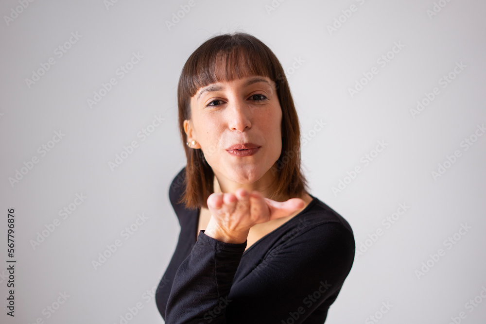 Portrait of a girl on white background. Brown short hair girl. Girl sent an air kiss. Portrait of a girl on white background. Brown short hair girl. Girl sent an air kiss.