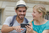 happy young couple taking selfie with phone