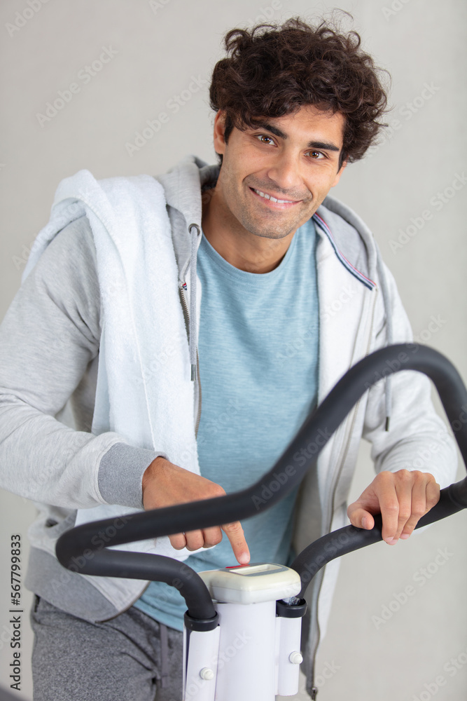 Fototapeta premium handsome gym man running on the treadmill