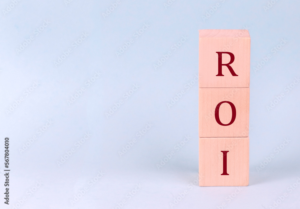 Return on Investment, ROI on wooden cubes on a blue background Return on Investment, ROI on wooden cubes on a blue background