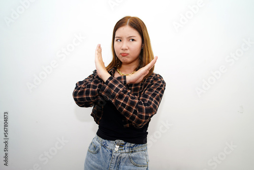 Beautiful Asian woman with hand gesture pose rejection or prohibition with copy space