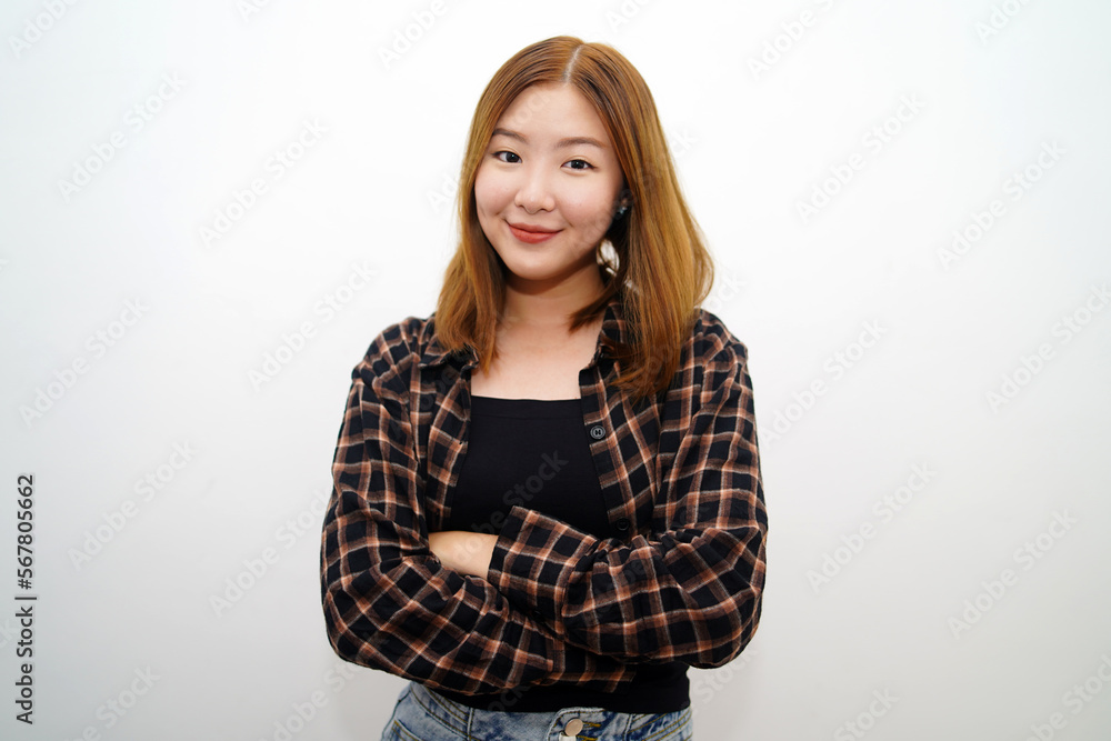Portrait of a confident smiling girl standing with arms folded and looking at the camera isolated over white background. Portrait of a confident smiling girl standing with arms folded and looking at the camera isolated over white background.