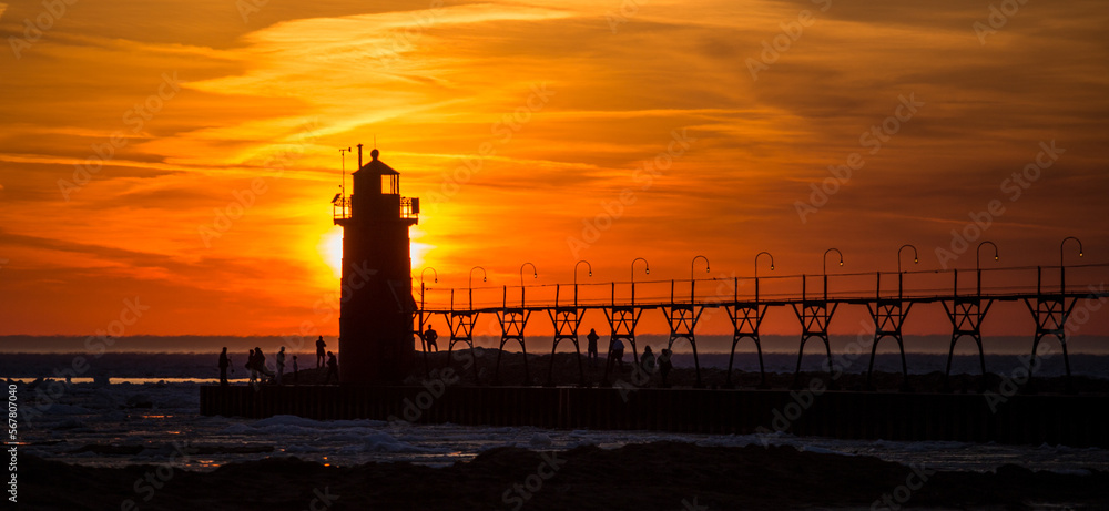 sunset behind lighthouse
