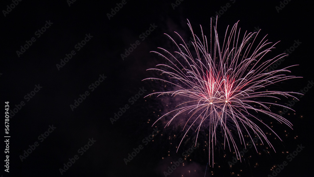 pink fireworks in the night sky with copy space. new year, anniversary, festive concept