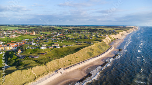 The shoreline of Denmark around the village Lønstrup on a beautiful summer day seen from the air