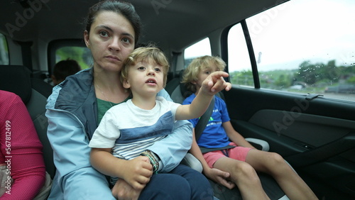 Mother and boy traveling together in the backseat of a car
