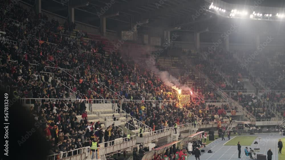 Football, soccer supporter fans in full stadium celebrate a goal with