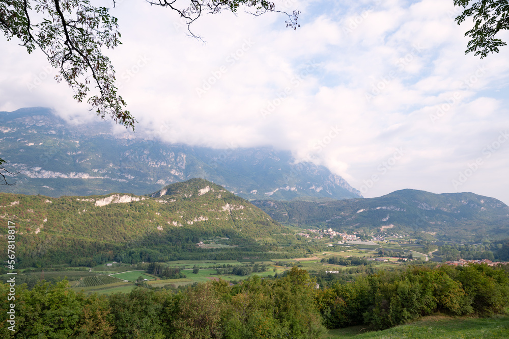 Panorama of Trento. Mountains, clouds, green forests and hiking trails. High quality photo