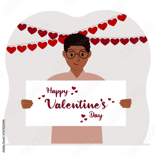 Happy man holding a poster with text Happy Valentine's Day and red hearts. Love concept. Happy Valentine's Day wallpaper, poster, postcard or congratulation.