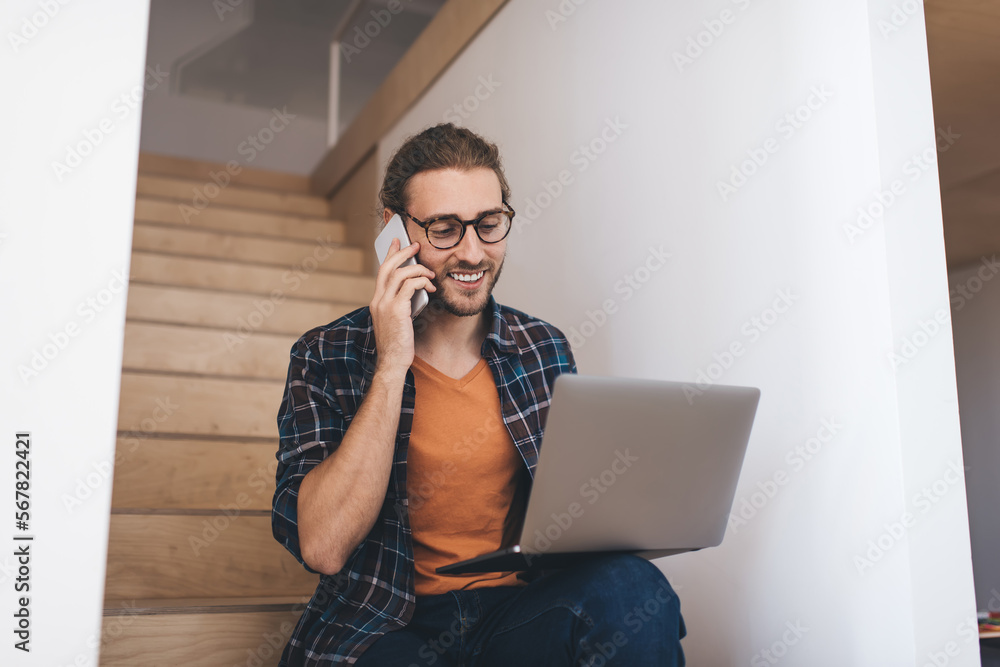 Millennial businessman working on stairs in office Millennial businessman working on stairs in office