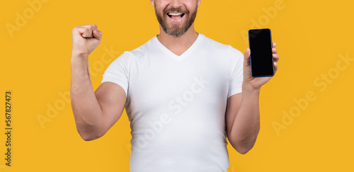 cropped view of man showing screen of phone. man showing phone screen with copy space