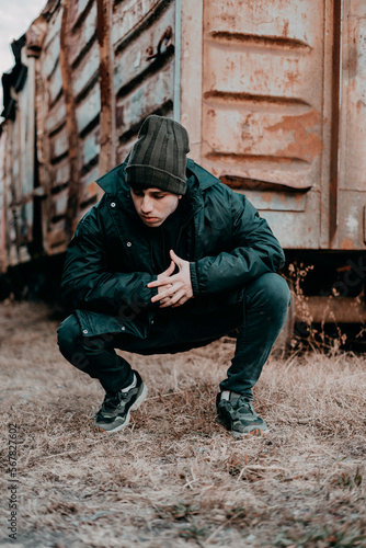 A young man wearing black winter clothing. A handsome young guy wearing black outfit.