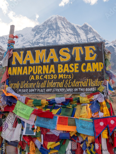 Annapurn Base camp (Nepal) arrival sign with prayer flags.