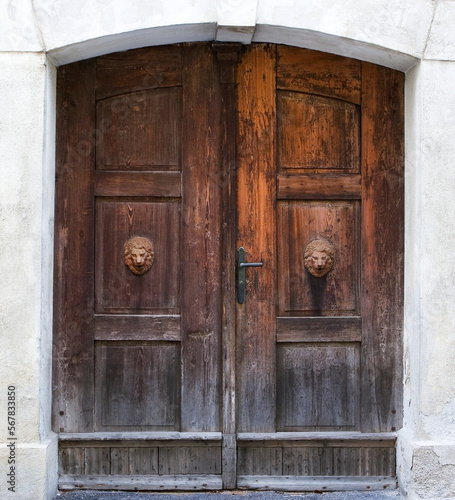 old closed and weathered brown wooden door,