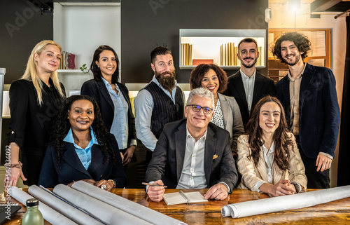 Multiethnic joyful business people looking at camera inside corporate office for a group photo while working together on sustainable innovation project - Goal achievement concept