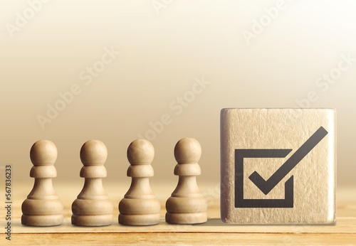 Quality control concept. Checklist icon and pepople wooden figures photo