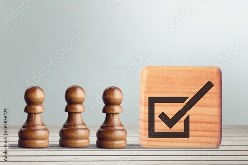 Quality control concept. Checklist icon and pepople wooden figures photo