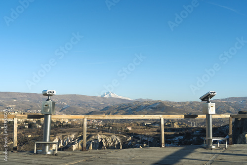 Touristic telescopes lookin through Cappadocia area, Nevşehir Turkey. One of the most touristic places in Turkey. Erciyes mountain on the horizon.