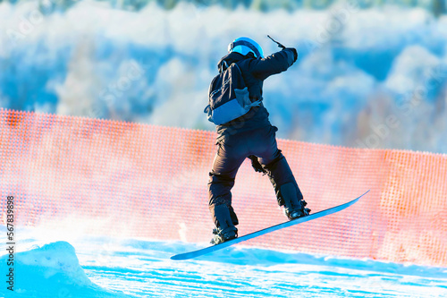 Wallpaper Mural Snowboarder on a snowboard jumps in high mountains. Snowboarding,training at the school of extreme sports. Torontodigital.ca