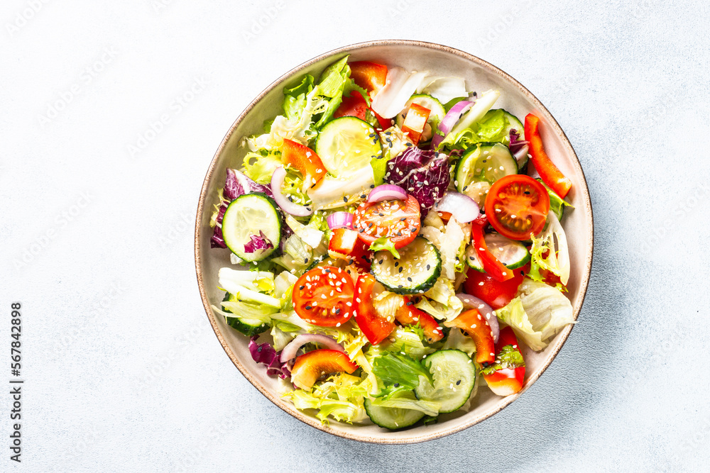 Vegan salad with green leaves, cucumber, paprika and tomatoes. Vegan salad with green leaves, cucumber, paprika and tomatoes.