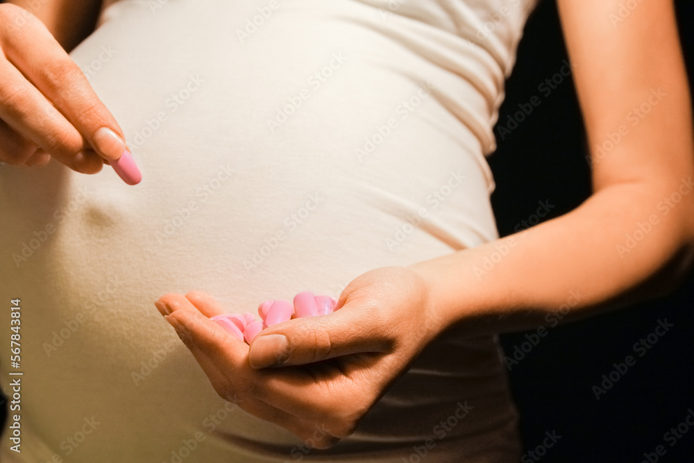 custom made wallpaper toronto digital.beautiful young pregnant woman on a black background with vitamins