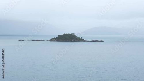 Small island, on a cloudy day, in front of Abraao beach in Ilha Grande in Brazil. photo