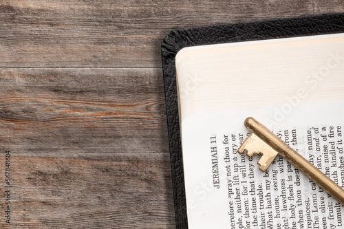 Antique key and open big Bible Book