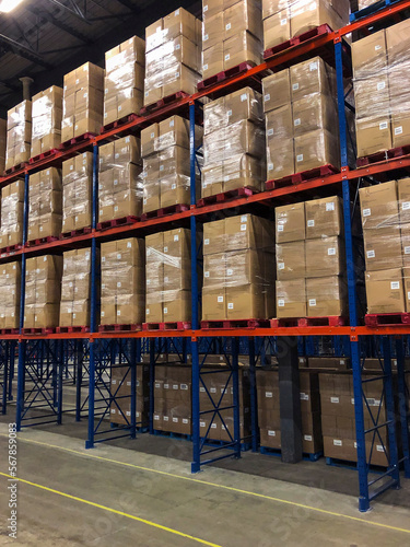 Pallets of boxes of paper towels stacked in distribution center. © Pierre