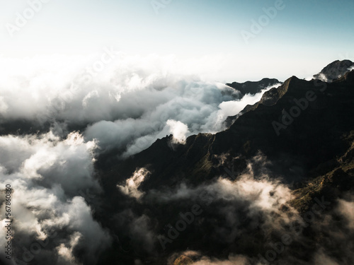Shot from drone,a shot of pico grande, a landscape bathed in sunlight,majestic mountains under the clouds