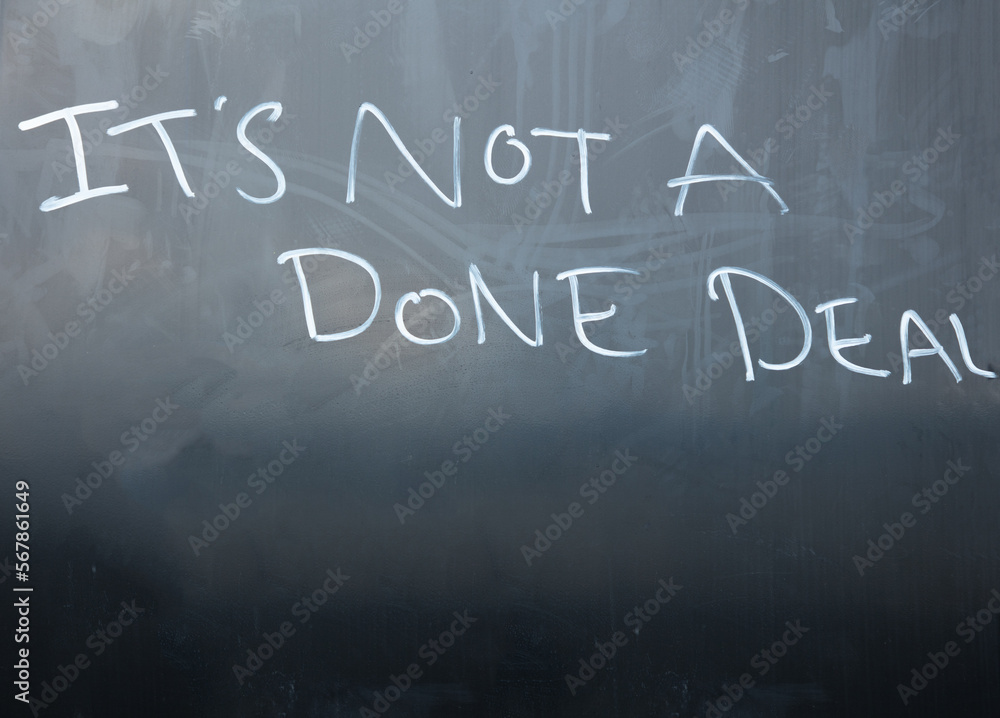 Obraz premium The words It's not a done deal are written in white on a dark blackboard.