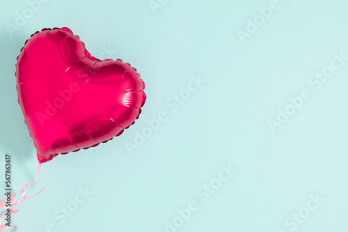 Valentine's Day background. Heart shaped balloon on blue background. Valentines Day. Balloon Heart. Flat lay, top view, copy space 